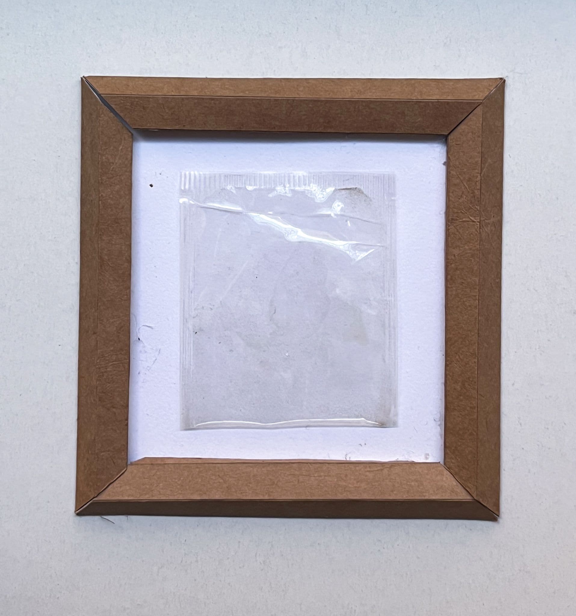  “Reframing.” Plastic tea bag wrapper, cereal box cardboard by Lizzie Wright. 