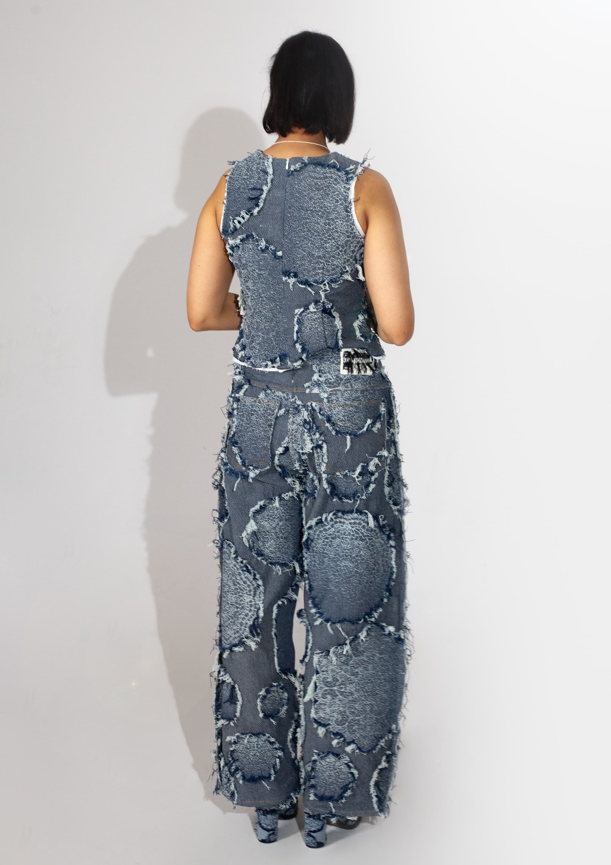 Jacquard woven indigo denim from GOTS-certified weaving mill Gommatex in Italy. Inspired by the crochet doilies my grandmother used to make, woven in a fil-coupé technique.