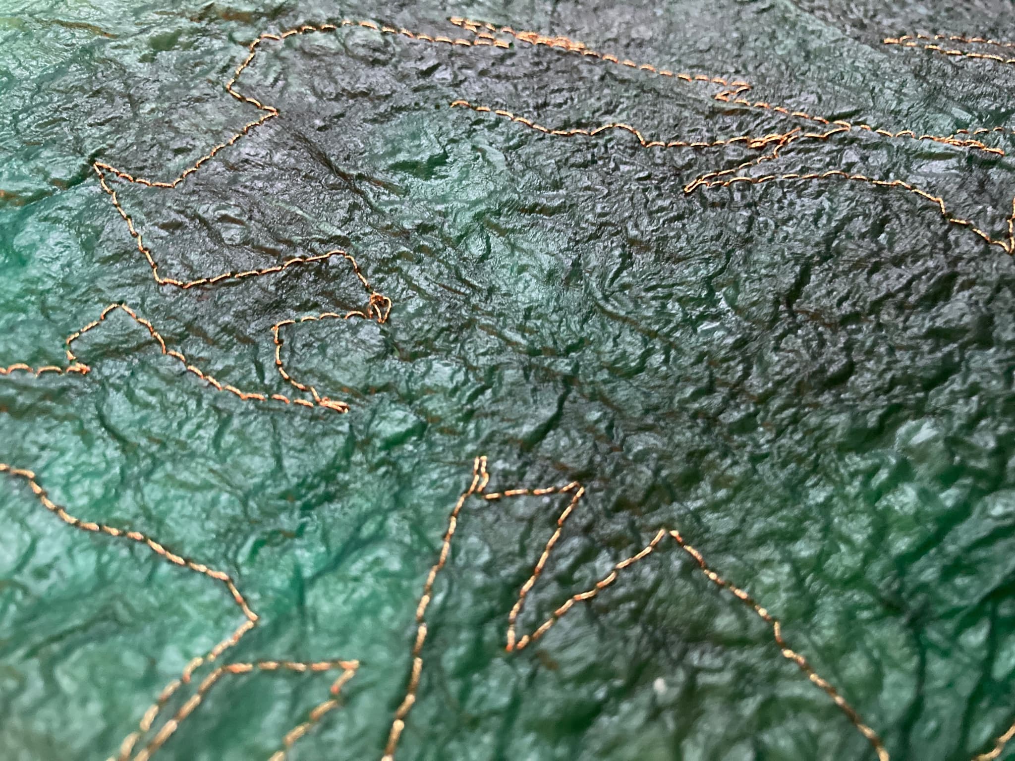A close up of the texture of 'The Ocean Purse' made of kombucha leather